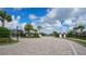 Gated community entrance featuring beautiful landscaping and paved roads at 17320 Polo Trl, Bradenton, FL 34211