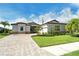 Beautiful single-story home with a tile roof, manicured lawn, and a paver driveway at 17320 Polo Trl, Bradenton, FL 34211