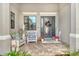 Inviting front porch with cozy seating, elegant decor, and a welcoming entrance at 17320 Polo Trl, Bradenton, FL 34211