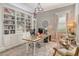 Bright home office with custom bookshelves, decorative lighting and comfortable seating area at 17320 Polo Trl, Bradenton, FL 34211