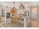 Stylish kitchen featuring a large island with barstool seating, pendant lights, and stainless appliances at 17320 Polo Trl, Bradenton, FL 34211