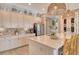 Open kitchen with white cabinets, stainless steel appliances, and a large center island, ideal for cooking and socializing at 17320 Polo Trl, Bradenton, FL 34211