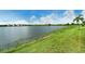 Scenic lake view with lush green shoreline and clear blue sky at 17320 Polo Trl, Bradenton, FL 34211