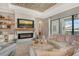 Comfortable living room with modern fireplace, decorative shelves, and open view of the lake at 17320 Polo Trl, Bradenton, FL 34211