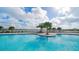 Expansive community pool with sun loungers for residents to relax and enjoy at 17320 Polo Trl, Bradenton, FL 34211