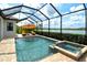 Sparkling screened-in pool and spa area with sun umbrella and serene lake views at 17320 Polo Trl, Bradenton, FL 34211
