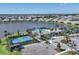Overhead view of community with pool, tennis courts, lake, and single-Gathering homes at 17823 Cherished Loop, Bradenton, FL 34211