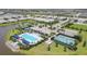 Aerial shot of the community amenities, showcasing the pool, pickleball courts, and surrounding landscaping at 17823 Cherished Loop, Bradenton, FL 34211
