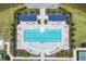 Birds eye view of the community pool with sun loungers and umbrellas, all surrounded by lush landscaping at 17823 Cherished Loop, Bradenton, FL 34211