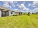 Expansive backyard with lush lawn and manicured landscaping bordering the home at 17823 Cherished Loop, Bradenton, FL 34211