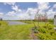 Lush backyard view overlooking a serene pond, enhancing the peaceful ambiance of the property at 17823 Cherished Loop, Bradenton, FL 34211