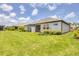 Charming backyard with a well-maintained lawn and a screened lanai for outdoor relaxation at 17823 Cherished Loop, Bradenton, FL 34211