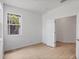 Well-lit room featuring wood-look flooring, white walls, a window, and a doorway at 17823 Cherished Loop, Bradenton, FL 34211