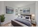 Stylishly furnished bedroom with large bed, side tables, lamps and calming art prints on the wall at 17823 Cherished Loop, Bradenton, FL 34211