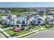 Exterior view of the community clubhouse with palm trees and flowerbeds surrounded by lush green lawns at 17823 Cherished Loop, Bradenton, FL 34211