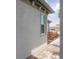 Side view of home with stucco siding, showing a window with white trim and walkway with colorful bushes at 17823 Cherished Loop, Bradenton, FL 34211