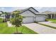Charming, light gray home with a two-car garage, brick paved driveway and well-manicured landscaping at 17823 Cherished Loop, Bradenton, FL 34211