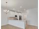 Open kitchen featuring white cabinets, stainless steel appliances, and a large island with seating at 17823 Cherished Loop, Bradenton, FL 34211