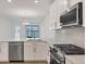 Close-up of a kitchen showcasing a stainless steel dishwasher, and range with view of the lake beyond at 17823 Cherished Loop, Bradenton, FL 34211