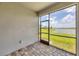 A beautiful screened in patio, with tiled floors, overlooks grass, water and neighboring homes at 17823 Cherished Loop, Bradenton, FL 34211