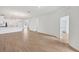 Bright and open living room featuring wood-look tile floors and recessed lighting at 17823 Cherished Loop, Bradenton, FL 34211