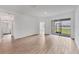 Spacious room with light wood flooring, sliding glass doors to the outdoors and bathroom access at 17823 Cherished Loop, Bradenton, FL 34211