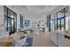 Bright and open lobby area with modern furnishings, artwork, and large windows at 17823 Cherished Loop, Bradenton, FL 34211