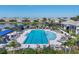 Beautiful community pool with lounge chairs, palm trees, and a lake view providing a resort style experience at 17823 Cherished Loop, Bradenton, FL 34211