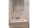 Bathroom vanity with white sink, brushed-nickel faucet, storage, and mirrored medicine cabinet at 1880 Sunny Dr # F35, Bradenton, FL 34207