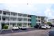 Three-story apartment building shows parking lot, exterior stairs, and a green-painted middle story at 1880 Sunny Dr # F35, Bradenton, FL 34207