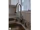 Stainless-steel kitchen sink with a brushed-nickel faucet and soap dispenser, complete with a view of the window at 1880 Sunny Dr # F35, Bradenton, FL 34207