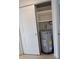 Water heater located inside of a shelved closet with white sliding doors and blonde wood flooring at 1880 Sunny Dr # F35, Bradenton, FL 34207