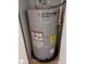AO Smith Signature 100 water heater inside of a shelved closet with a black safety basin at 1880 Sunny Dr # F35, Bradenton, FL 34207