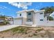 Modern two-story home featuring a clean white facade, gray accents, and a wide driveway at 2065 Goldenrod St, Sarasota, FL 34239