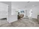 Open-concept living room featuring sleek furniture, neutral decor, and a large window with natural light at 2065 Goldenrod St, Sarasota, FL 34239