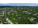 Aerial view of a leafy neighborhood featuring a park with a pond and fountain offering a serene community setting at 2124 Clematis Pl, Sarasota, FL 34239