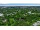 Beautiful aerial view showcasing neighborhood with lush greenery, pond, and distant cityscape for a peaceful living environment at 2124 Clematis Pl, Sarasota, FL 34239