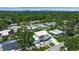 Aerial view of modern home with lush landscaping and a contemporary design in a green neighborhood at 2124 Clematis Pl, Sarasota, FL 34239