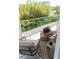 Relaxing balcony with comfortable seating and scenic views of the surrounding lush greenery at 2124 Clematis Pl, Sarasota, FL 34239