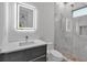 Modern bathroom with marble tile, LED mirror, and sleek vanity at 2124 Clematis Pl, Sarasota, FL 34239