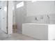Modern bathroom featuring a soaking tub, walk in shower, and contemporary fixtures at 2124 Clematis Pl, Sarasota, FL 34239