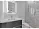 Sleek bathroom with an LED mirror, vanity, and glass-enclosed shower with marble tile at 2124 Clematis Pl, Sarasota, FL 34239