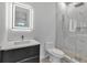 Modern bathroom with a lighted mirror, sleek vanity, toilet, and glass-enclosed shower at 2124 Clematis Pl, Sarasota, FL 34239