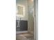 Modern bathroom featuring floating vanity with lighted mirror and walk-in shower with marble tile at 2124 Clematis Pl, Sarasota, FL 34239