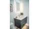Modern bathroom vanity with a lighted mirror, sleek faucet, and stylish decor at 2124 Clematis Pl, Sarasota, FL 34239