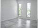 Bright, minimalist bedroom with sleek tile floors and well-lit by two large windows at 2124 Clematis Pl, Sarasota, FL 34239