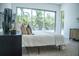 Bright bedroom with view to the backyard, accentuated with stylish decorations and a cozy rug at 2124 Clematis Pl, Sarasota, FL 34239