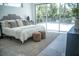 Bright bedroom with view to the backyard, accentuated with stylish decorations and a cozy rug at 2124 Clematis Pl, Sarasota, FL 34239