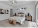 Bedroom with modern decor, a neutral color palette, and stylish furniture, including a tufted headboard at 2124 Clematis Pl, Sarasota, FL 34239
