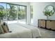 Bright bedroom featuring a view of the backyard, decorative pillows and a wicker cabinet at 2124 Clematis Pl, Sarasota, FL 34239